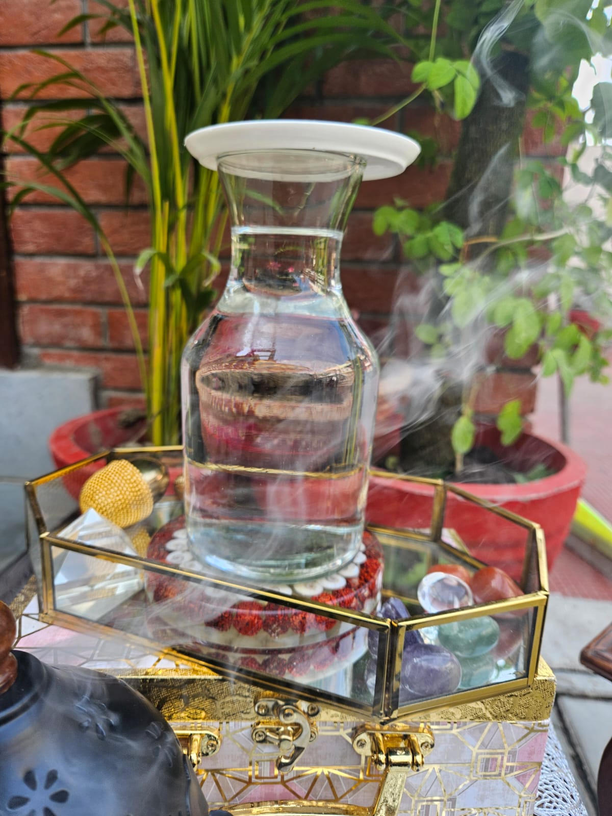 A ritual setting with crystal tree, candle and water